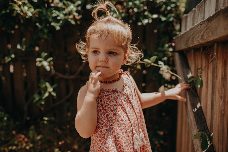 Kids Bohemian inspired, floral printed dress. Adjustable straps, border print and cotton neck tassels. Border floral print in multi colour