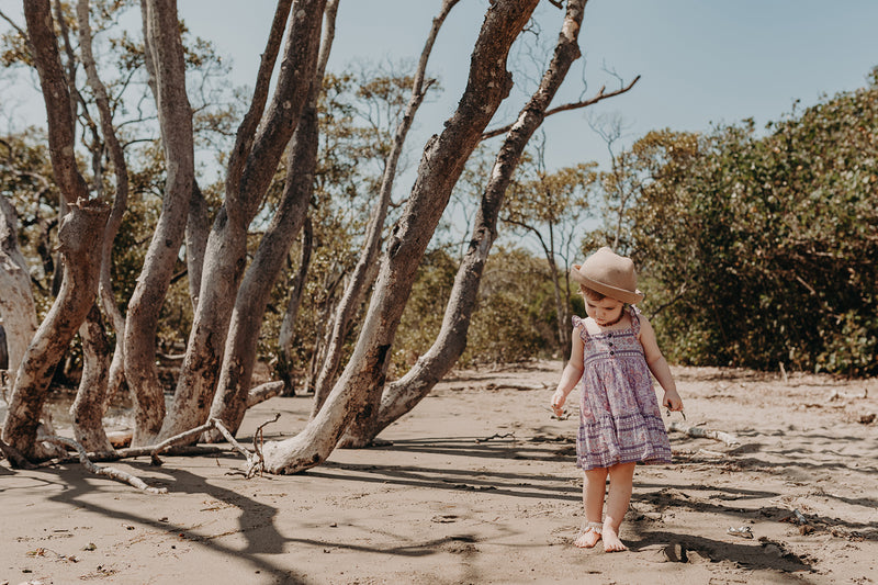 Bohemian style, Kids cotton dress featuring an exclusive placement print in pink, frilled sleeves and coconut buttons. Exclusive to We the Wild Collective