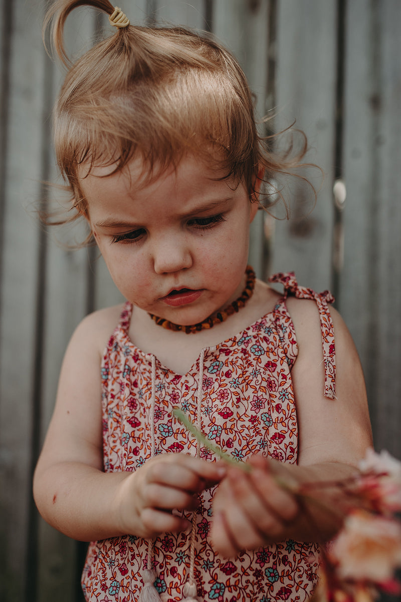 Kids Bohemian inspired, floral printed dress. Adjustable straps, border print and cotton neck tassels. Border floral print in multi colour